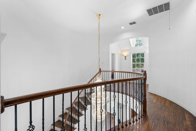 1891 Mustang Trl, Frisco, TX 75033 - corridor with an upstairs landing, wood finished floors, arched walkways, and recessed lighting