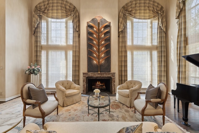 living area with plenty of natural light, baseboards, and a fireplace