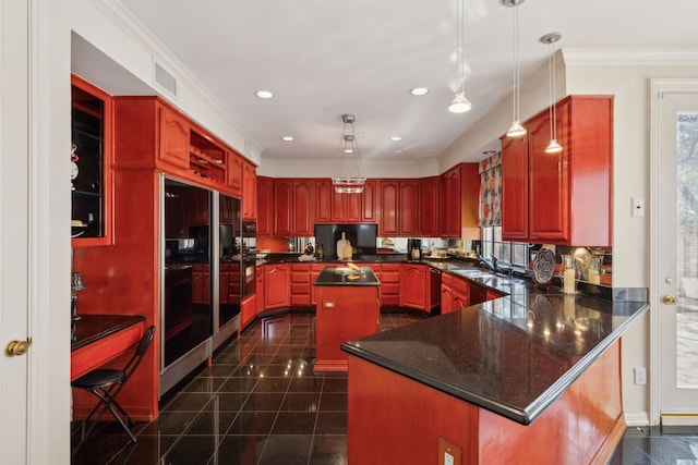kitchen featuring a peninsula, crown molding, recessed lighting, granite finish floor, and a center island