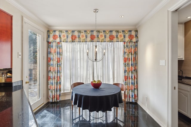 dining room with baseboards, granite finish floor, a chandelier, and ornamental molding