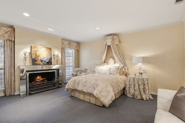 bedroom featuring a lit fireplace, carpet, and crown molding