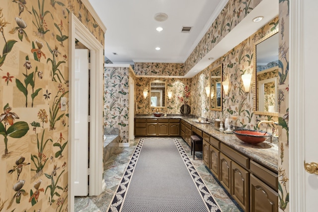 full bath featuring visible vents, crown molding, double vanity, wallpapered walls, and recessed lighting