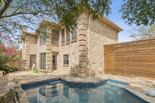 pool with a fenced backyard and a patio area