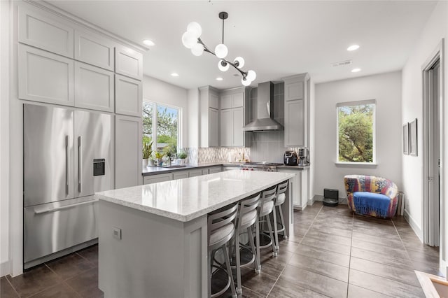 276 Currie St, Fort Worth, TX 76107 - kitchen featuring wall chimney range hood, a wealth of natural light, high end refrigerator, and gray cabinets