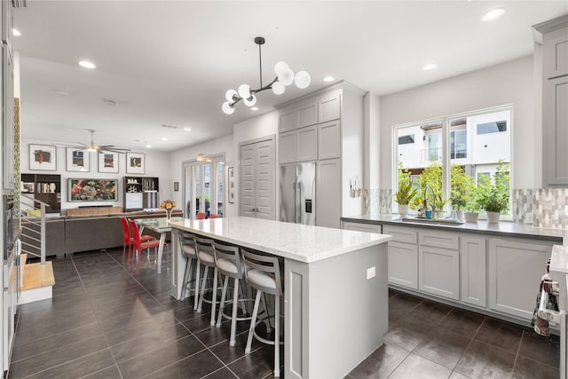 276 Currie St, Fort Worth, TX 76107 - kitchen with a sink, stainless steel refrigerator with ice dispenser, plenty of natural light, and a kitchen island