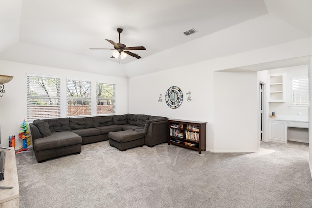 living area featuring a ceiling fan, visible vents, a raised ceiling, and carpet flooring