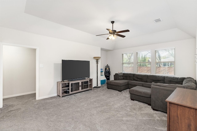 living room featuring lofted ceiling, a ceiling fan, visible vents, and carpet