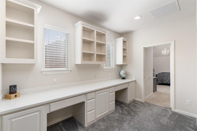 unfurnished office with built in study area, baseboards, carpet flooring, visible vents, and recessed lighting