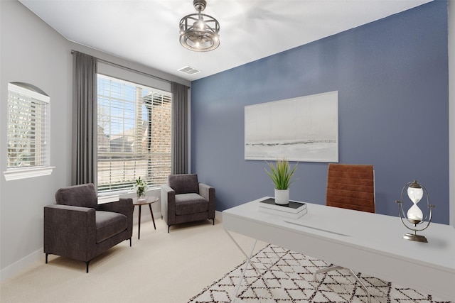 carpeted office space with visible vents and a healthy amount of sunlight