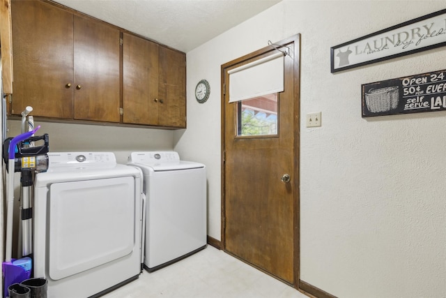 clothes washing area featuring baseboards, separate washer and dryer, cabinet space, and light floors