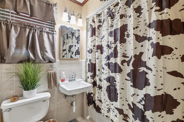 bathroom with tile walls, toilet, and a shower with curtain