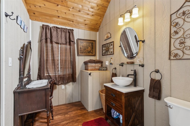 bathroom featuring vanity, vaulted ceiling, toilet, wood ceiling, and wood finished floors