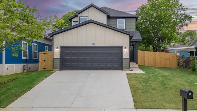 view of front facade featuring a yard, board and batten siding, a shingled roof, and a garage