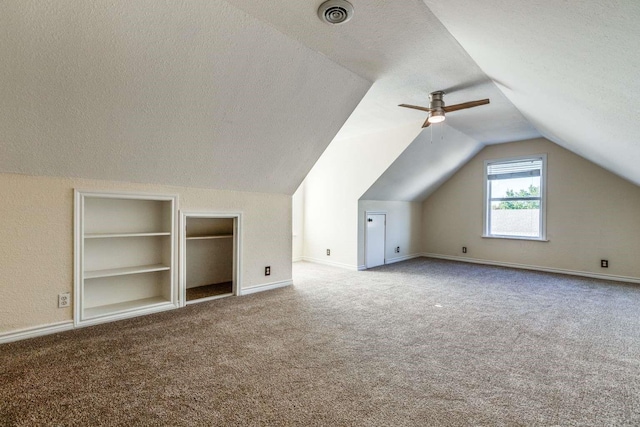 845 County Road 490, Princeton, TX 75407 - bonus room with vaulted ceiling, carpet floors, built in shelves, a textured ceiling, and visible vents