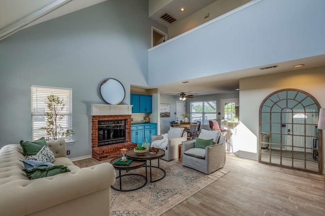 845 County Road 490, Princeton, TX 75407 - living room featuring a high ceiling, visible vents, a brick fireplace, and light wood finished floors