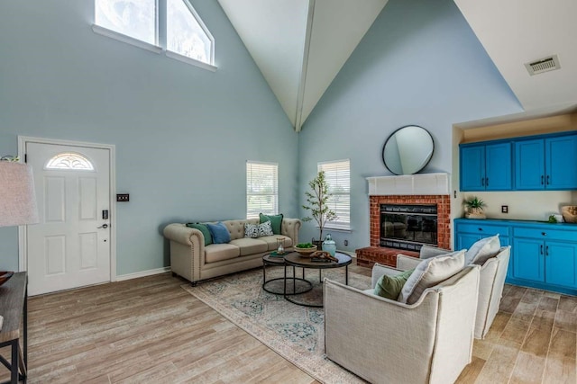 845 County Road 490, Princeton, TX 75407 - living room with a fireplace, high vaulted ceiling, light wood-style flooring, and visible vents