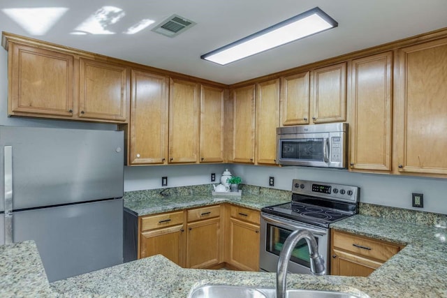 845 County Road 490, Princeton, TX 75407 - kitchen featuring light stone countertops, appliances with stainless steel finishes, and visible vents
