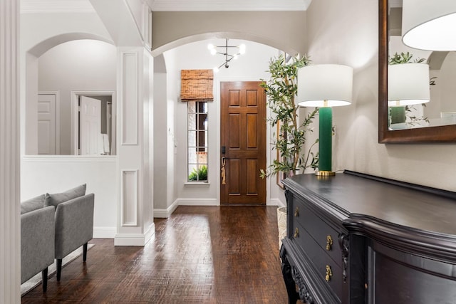 15596 Christopher Ln, Frisco, TX 75035 - foyer entrance with dark wood-style flooring, baseboards, arched walkways, and crown molding