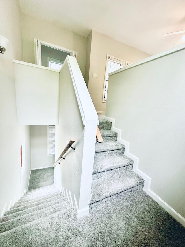 staircase with carpet flooring and baseboards