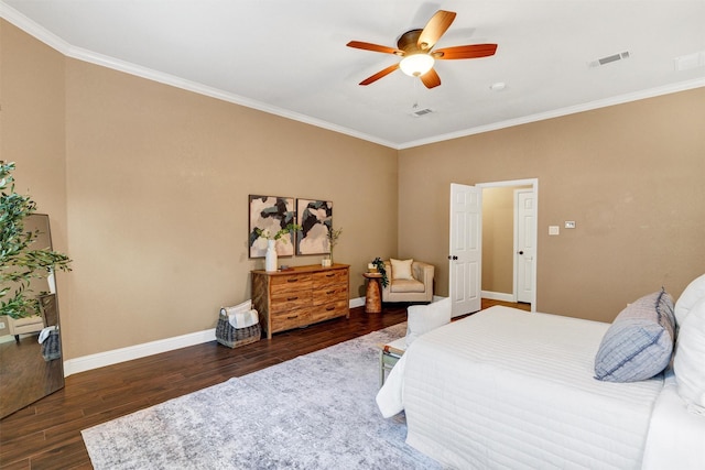 bedroom featuring wood finished floors, visible vents, baseboards, and ornamental molding
