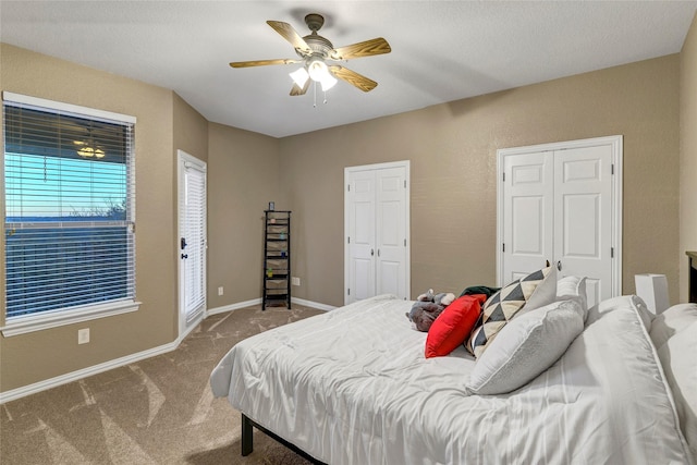 bedroom featuring baseboards, a ceiling fan, carpet flooring, and multiple closets