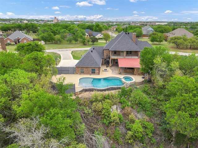view of swimming pool featuring stairs, a fenced backyard, a residential view, a patio, and a pool with connected hot tub