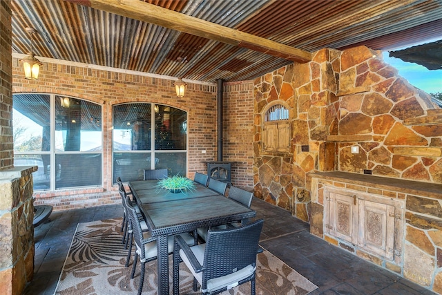 view of patio with outdoor dining area and a fireplace