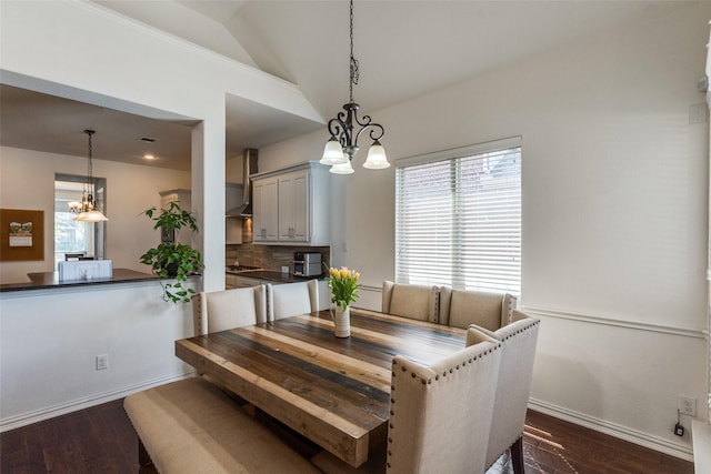12532 Princess Dr, Frisco, TX 75035 - dining area featuring a chandelier, vaulted ceiling, plenty of natural light, baseboards, and dark wood-style floors