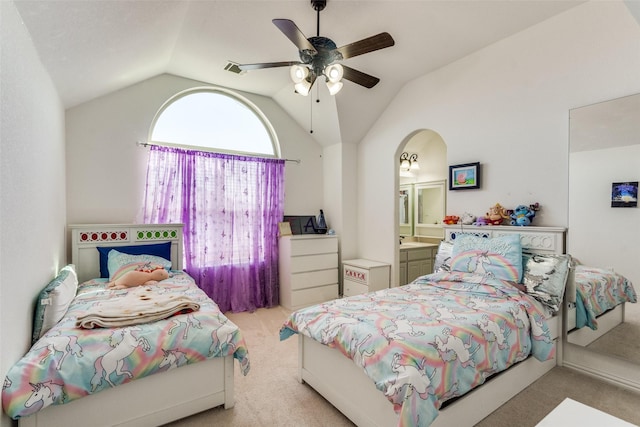 12532 Princess Dr, Frisco, TX 75035 - carpeted bedroom featuring vaulted ceiling, arched walkways, a ceiling fan, and connected bathroom