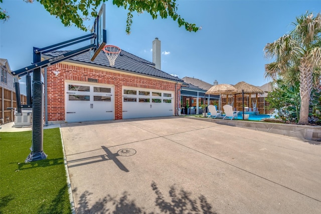 12532 Princess Dr, Frisco, TX 75035 - garage featuring concrete driveway and central air condition unit