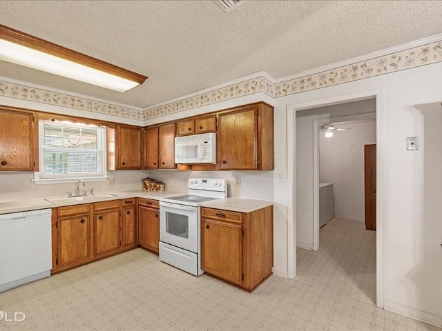 kitchen featuring light countertops, a sink, light floors, brown cabinets, and white appliances