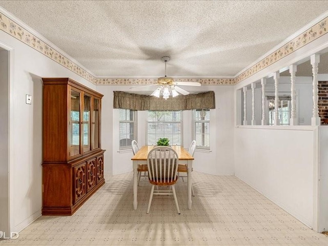 dining space featuring a textured ceiling, ceiling fan, tile patterned floors, and crown molding