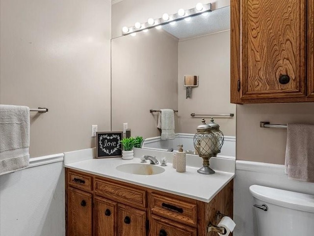 half bathroom with toilet and vanity