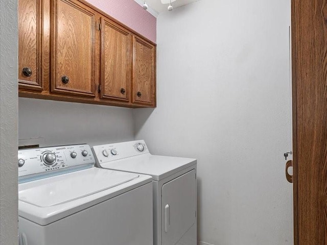 laundry area with washer and clothes dryer and cabinet space