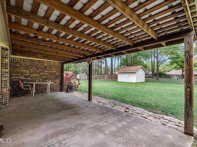 view of patio / terrace with a fenced backyard, an outbuilding, and a storage unit