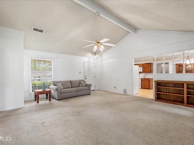 living area featuring a ceiling fan, light carpet, vaulted ceiling with beams, a textured ceiling, and visible vents