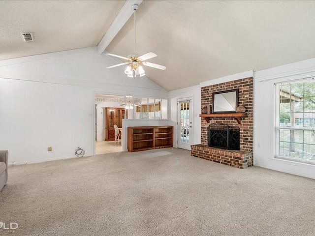 unfurnished living room featuring lofted ceiling with beams, carpet, a textured ceiling, visible vents, and a ceiling fan