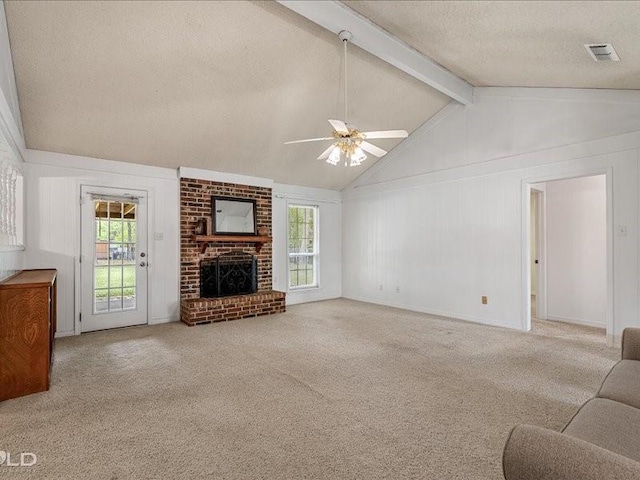 carpeted living area with a healthy amount of sunlight, visible vents, a textured ceiling, and a ceiling fan