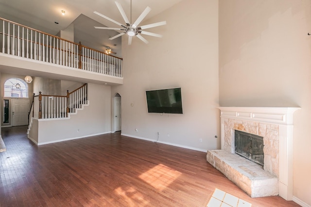 4920 Marineway Dr, Fort Worth, TX 76135 - unfurnished living room featuring stairway, a ceiling fan, high vaulted ceiling, a glass covered fireplace, and wood finished floors