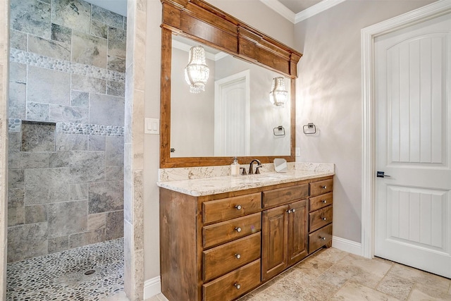 full bathroom featuring crown molding, tiled shower, vanity, a chandelier, and baseboards