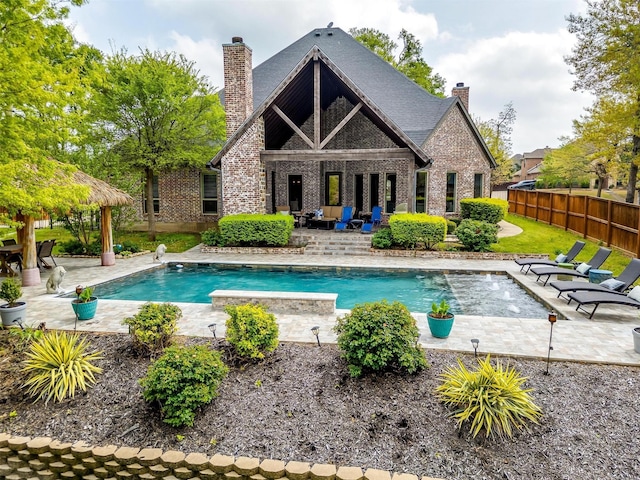 view of swimming pool featuring a patio, fence, and a fenced in pool