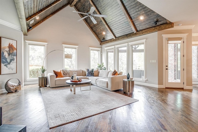 living area featuring high vaulted ceiling, a ceiling fan, wood finished floors, baseboards, and beamed ceiling