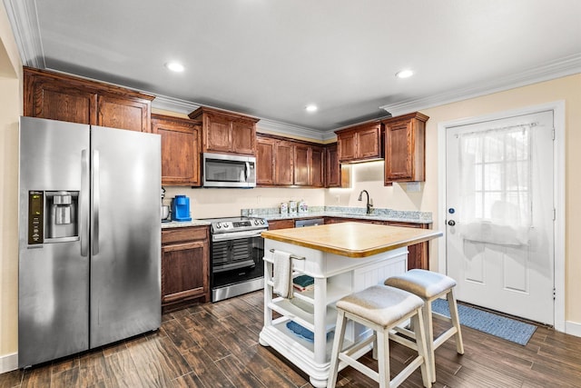 1321 S Montgomery St, Sherman, TX 75090 - kitchen featuring appliances with stainless steel finishes, crown molding, a sink, light countertops, and dark wood finished floors