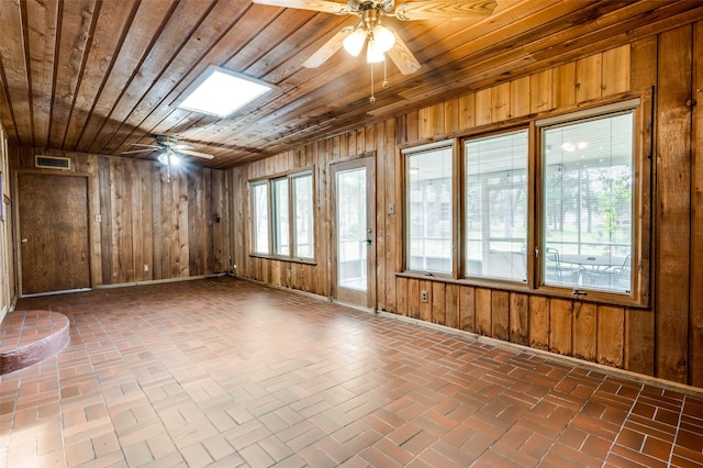 302 Comanche Dr, Gainesville, TX 76240 - spare room with visible vents, ceiling fan, wooden walls, and wood ceiling
