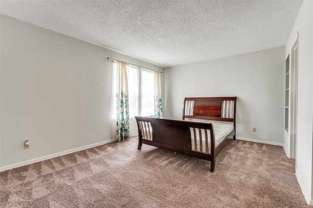 302 Comanche Dr, Gainesville, TX 76240 - carpeted bedroom with a textured ceiling and baseboards
