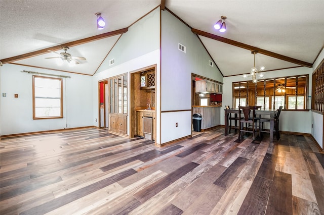 302 Comanche Dr, Gainesville, TX 76240 - interior space featuring visible vents, baseboards, wood finished floors, and ceiling fan with notable chandelier