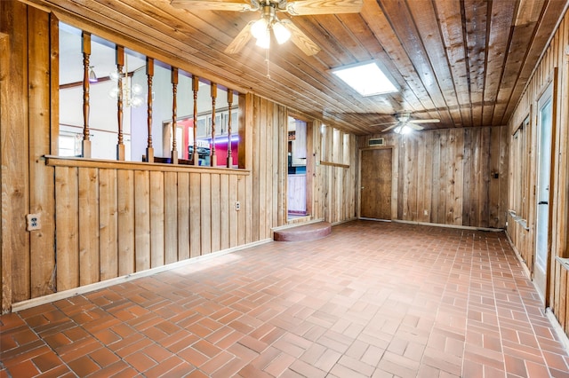 302 Comanche Dr, Gainesville, TX 76240 - spare room with wood walls, ceiling fan, brick floor, and wood ceiling