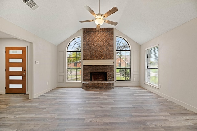 1581 Glenmore Dr, Lewisville, TX 75077 - unfurnished living room featuring ceiling fan, lofted ceiling, and a wealth of natural light