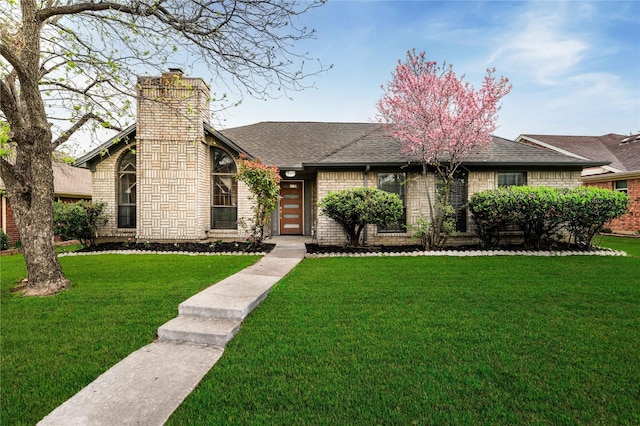 1581 Glenmore Dr, Lewisville, TX 75077 - view of front of home featuring a front yard, a chimney, and roof with shingles