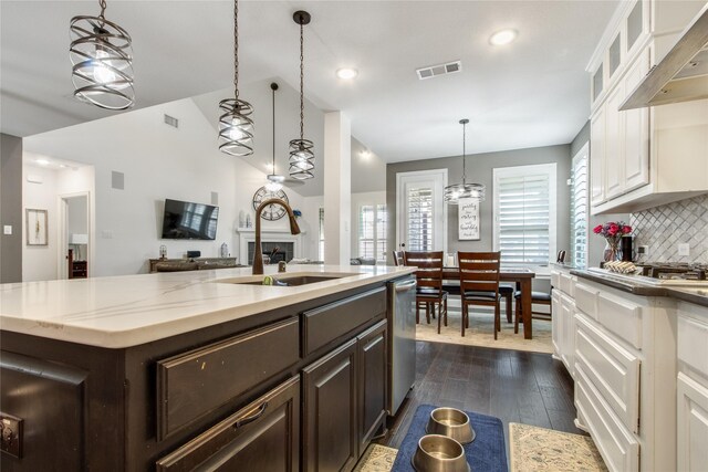 813 Pier St, Little Elm, TX 76227 - kitchen with a sink, dark brown cabinetry, white cabinetry, recessed lighting, and high vaulted ceiling